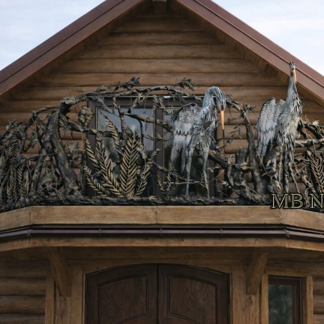 Organic steel balustrade with herons among forged branches