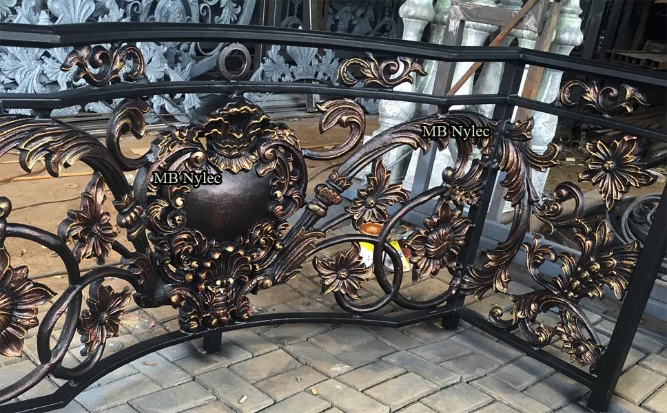 Oriental-style balcony railing BA81 with a central medallion and bronze scrolls in our workshop