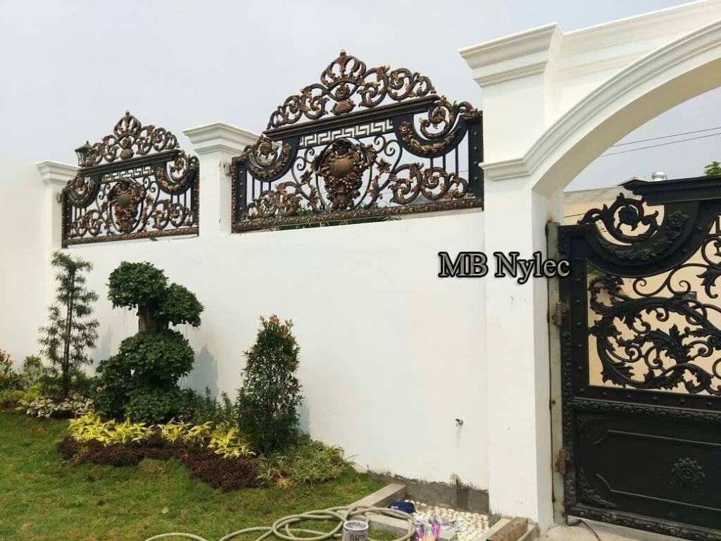 Two oriental fence panels BP130B above topiary on a white wall