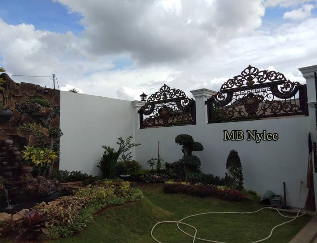 Oriental forged fence panels BP130B on top of a white garden wall