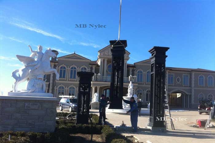 Columns of palace gate set BP50 during installation beside a horse sculpture