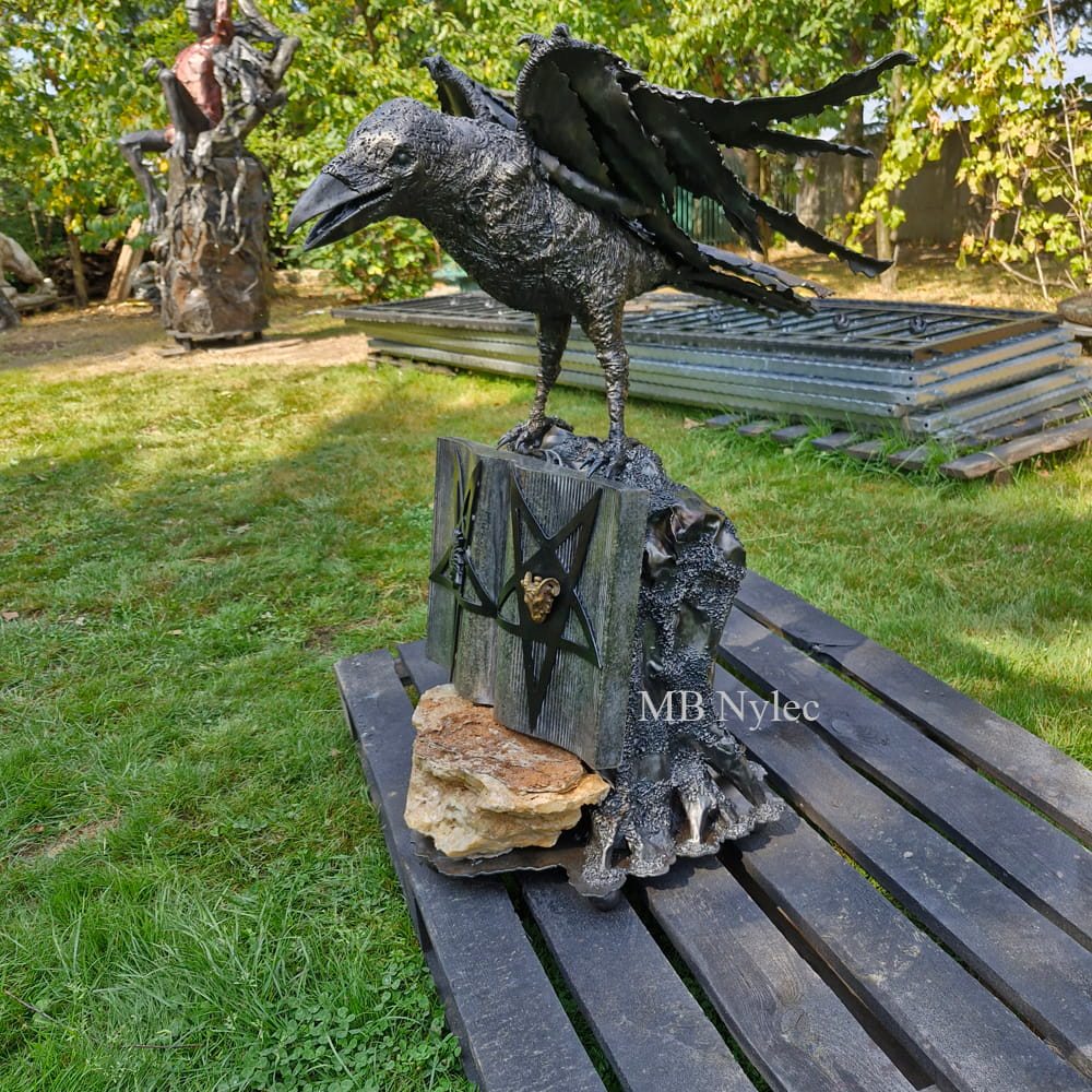 Pentagram and raven sculpture in a garden