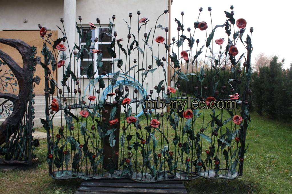 Forged poppy fence panel BM48 in a garden