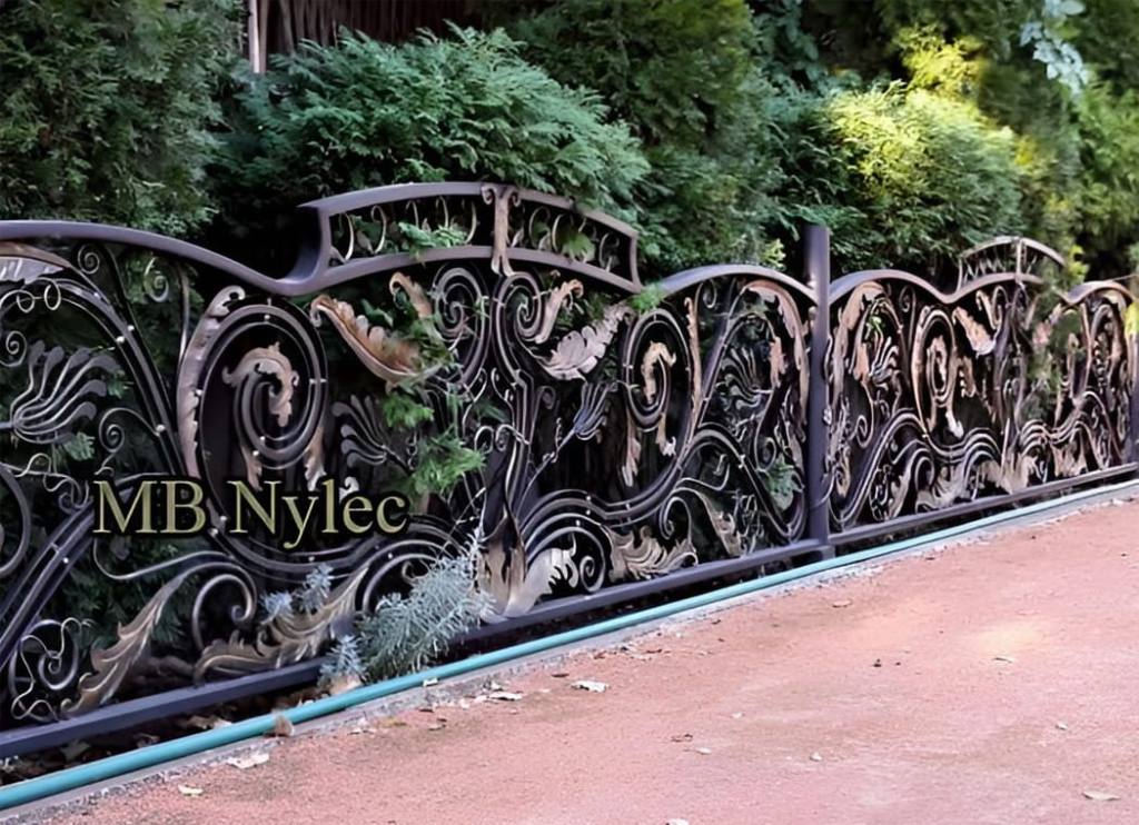 Rococo-baroque wrought iron fence BP246 with a wave of gilded forged leaves along a path