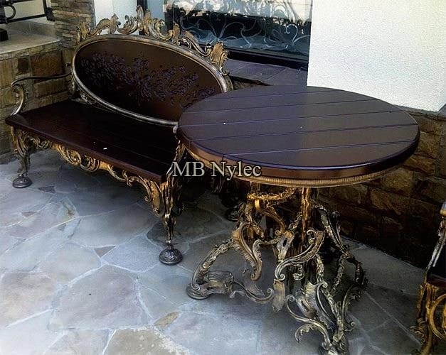 Round rococo table MK38 with a dark wooden top beside the carved bench MK4