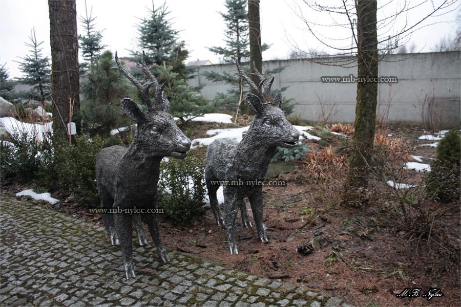 Two steel deer figures including Z4 in a garden in winter