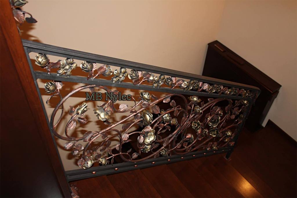 Stair railing BA4 with forged roses and climbing stems along a wooden staircase