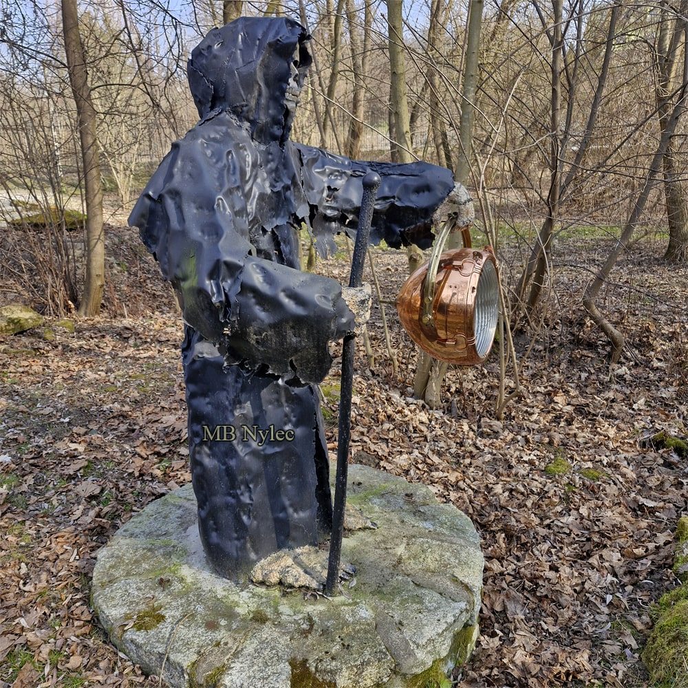 Sculpture of Death with an antique brass and copper lantern