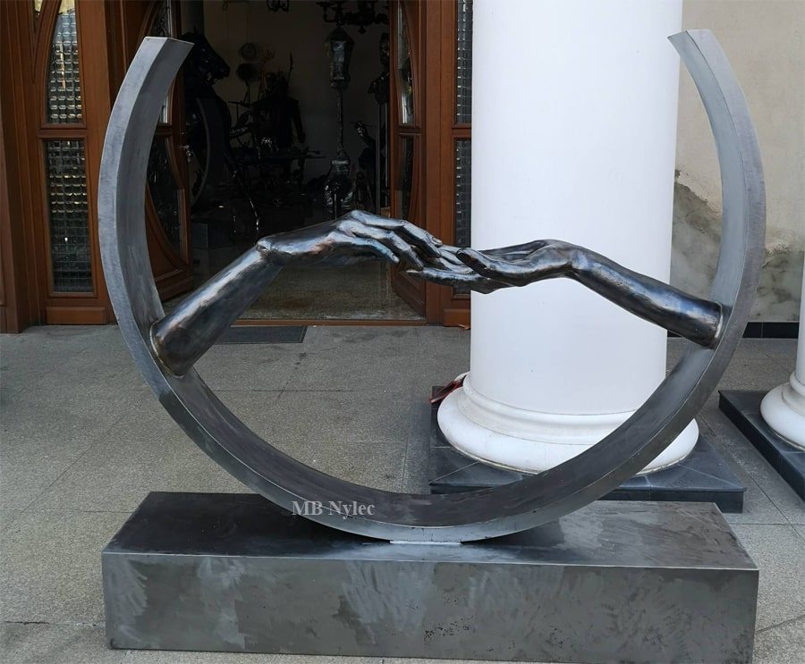Sculpture of love in a steel ring on a plinth by a column