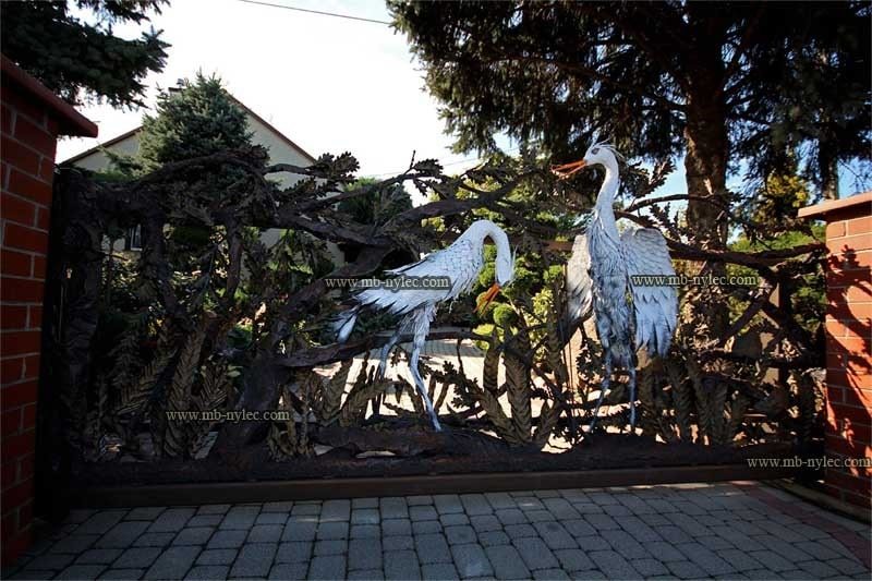 Sliding wrought iron gate BM37 with pale herons among forged reeds and branches
