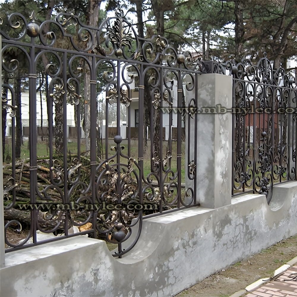 Traditional wrought iron fence BP35 with spear-topped bars and scrolls on a wall