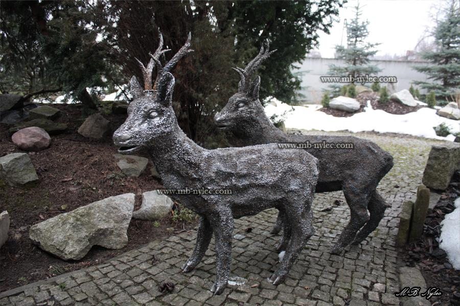 Steel roe deer Z4 standing on a cobbled path with a second figure behind