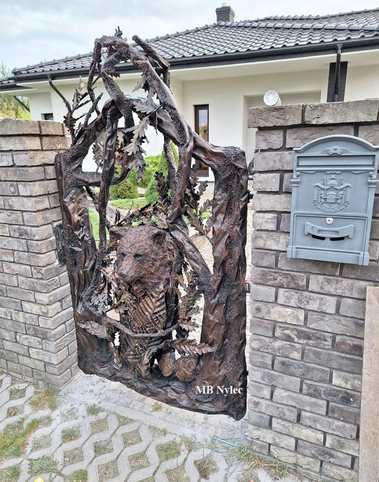 Steel sculpture wicket gate with a bear and a tree