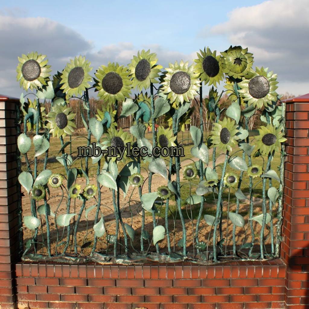 Forged fence span BM44 with yellow sunflowers about 200 cm high