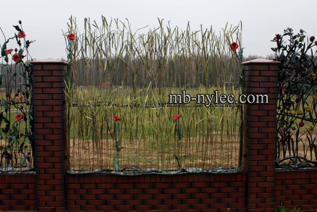 Fence BM47 with forged ears of grain and red flowers between brick pillars