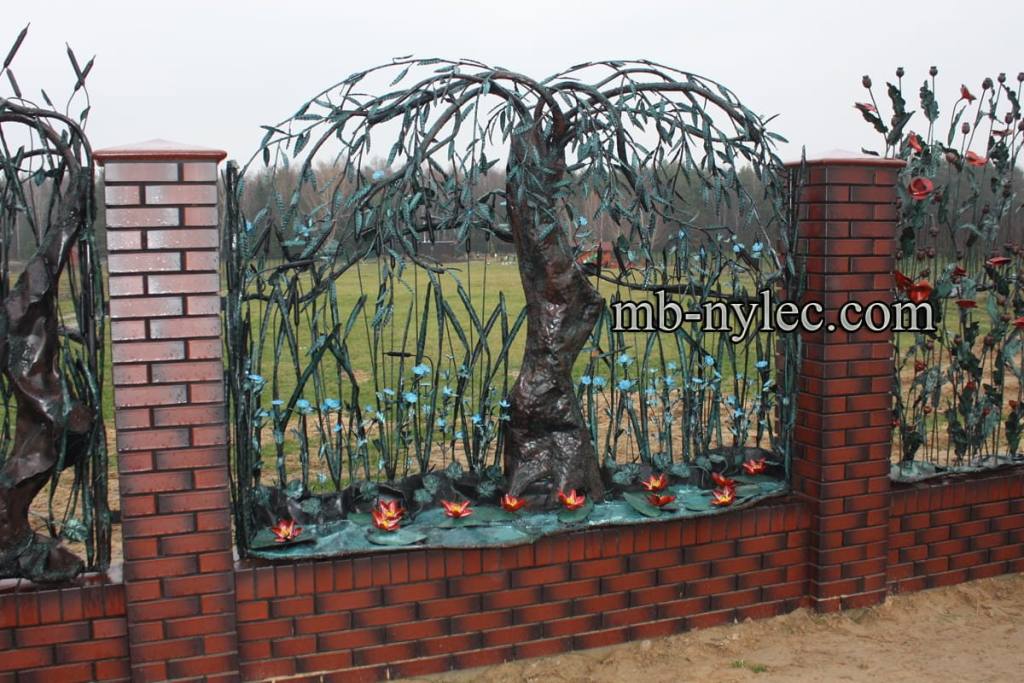 Weeping willow fence span BM43 between brick pillars with a field behind